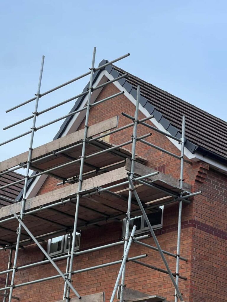 This is a photo of a roof which has just been repaired. There is a scaffold located at the gable end for access onto the roof. Works carried out by LS Roofing Harefield